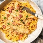 A bowl of pasta with chicken and bacon.
