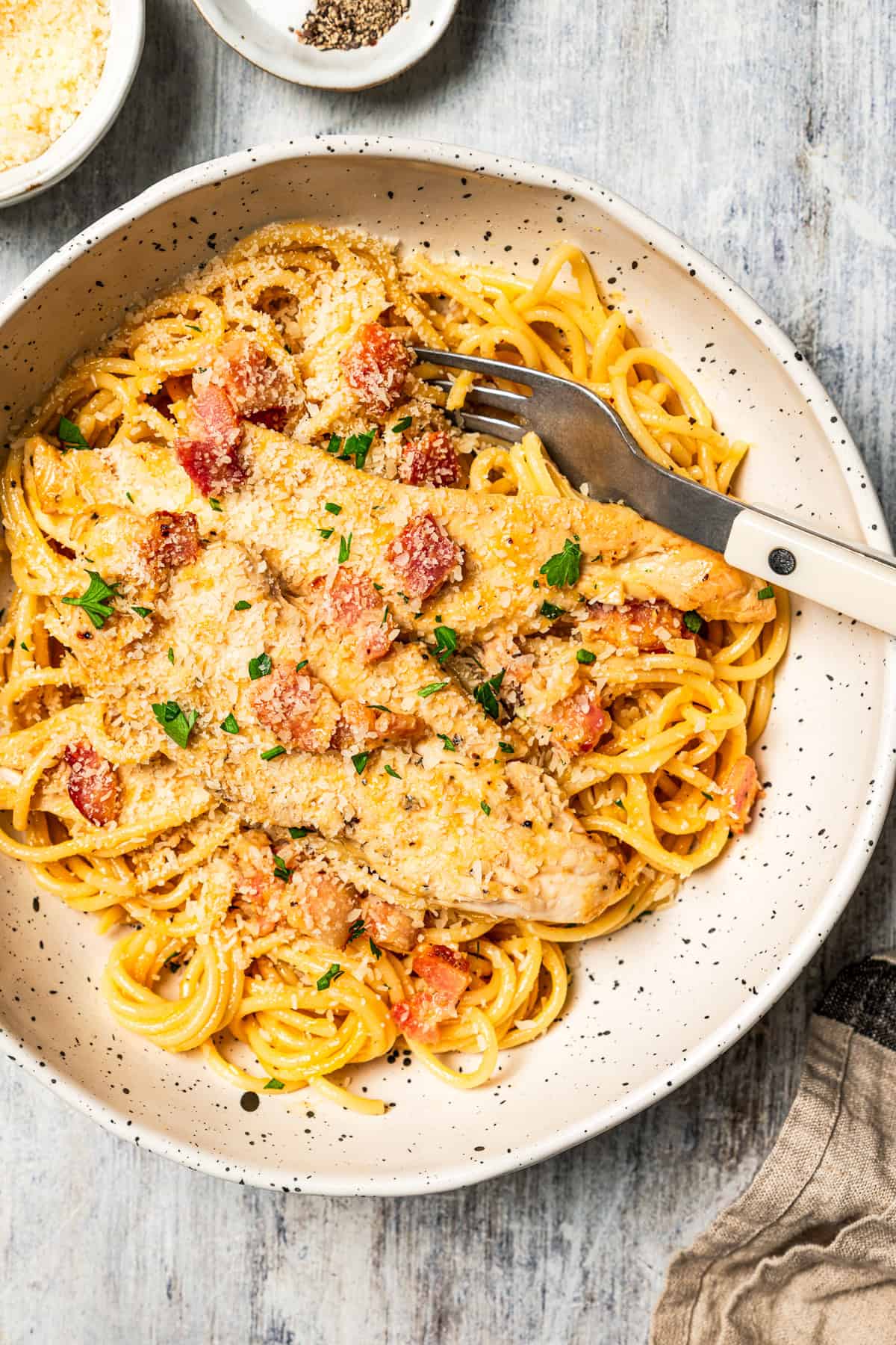 This chicken and bacon pasta is a 20-minute meal with tender linguine, juicy chicken, bacon, and parmesan in a creamy, Carbonara-style sauce. A bowl of pasta with chicken and bacon.