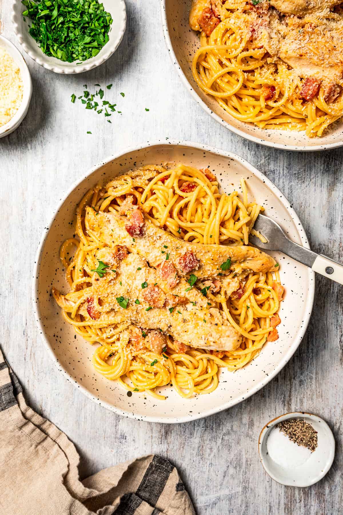 This chicken and bacon pasta is a 20-minute meal with tender linguine, juicy chicken, bacon, and parmesan in a creamy, Carbonara-style sauce. Creamy chicken and bacon pasta served in two dinner bowls.