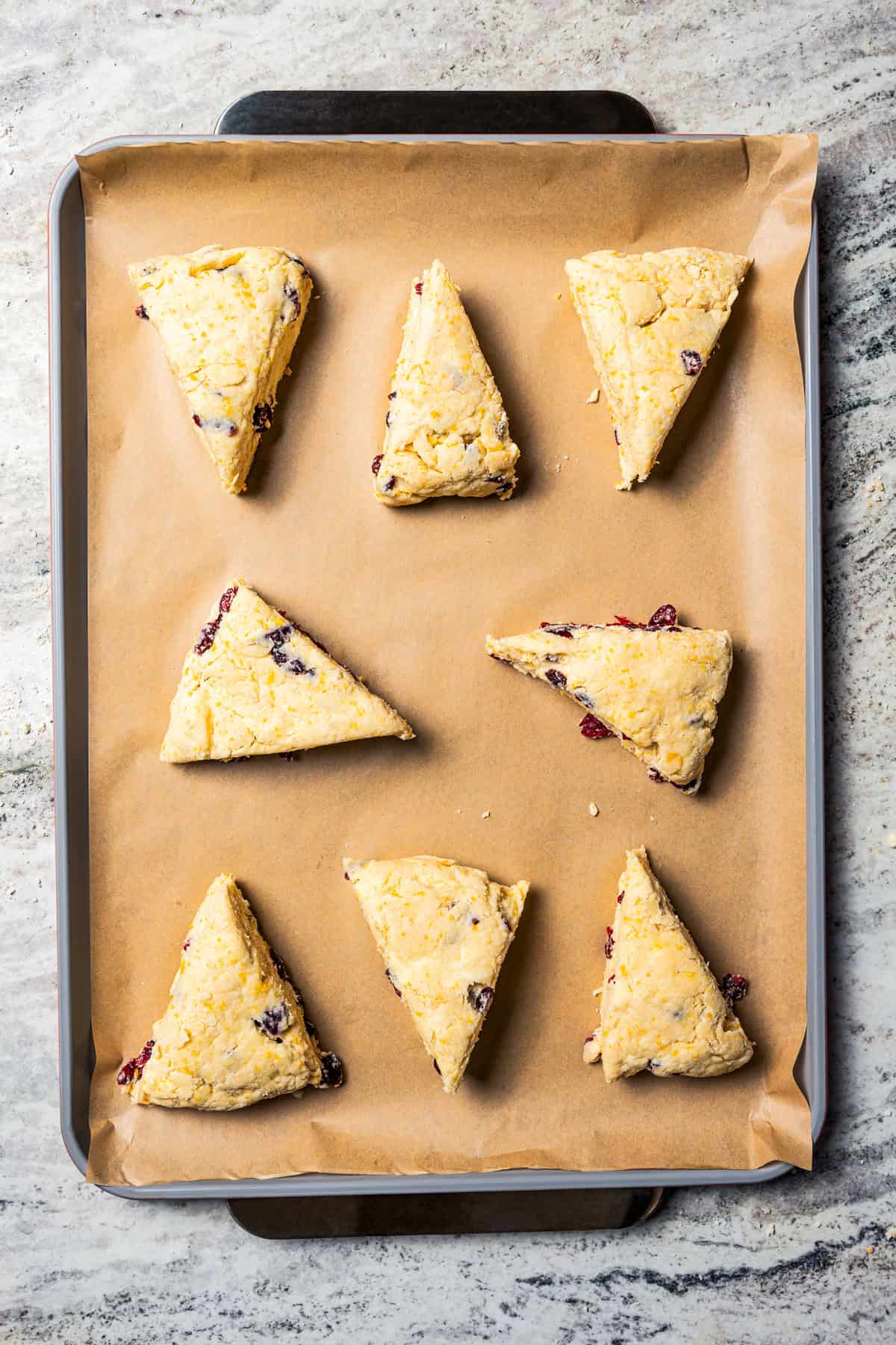 Unbaked scones on a baking sheet.