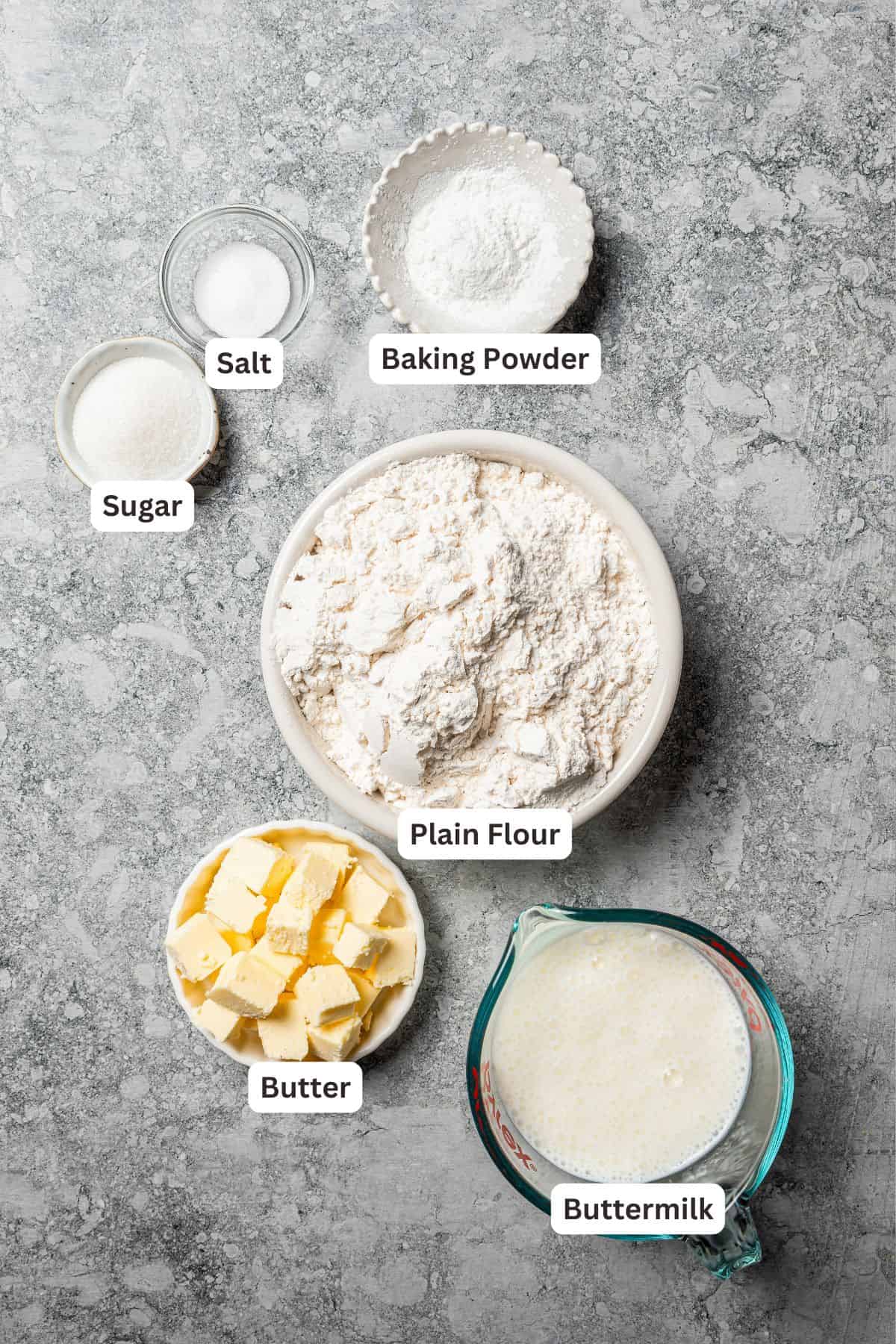 Butter swim biscuits are fluffy drop biscuits baked in a pool of butter! Crispy outside, soft inside, and easy to make with 5 ingredients. Butter swim biscuits ingredients with text labels overlaying each ingredient.