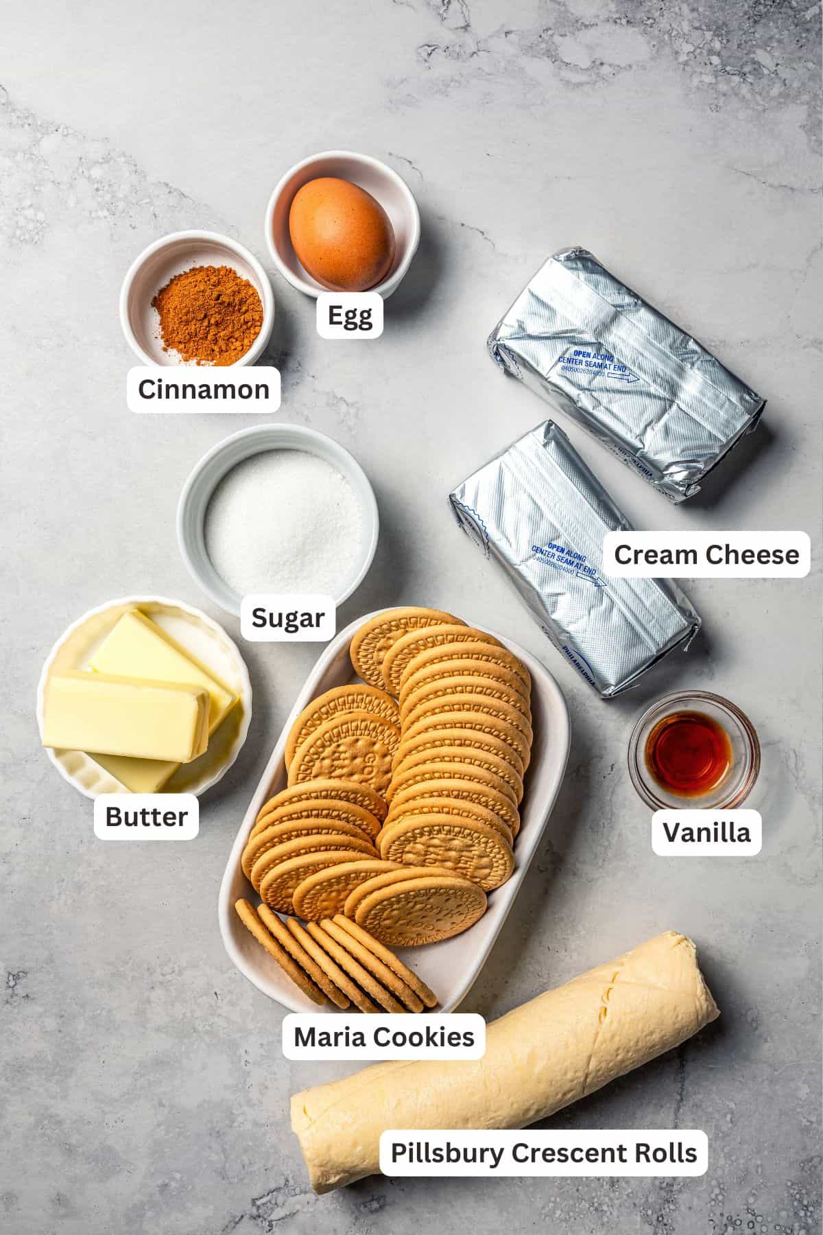 This churro cheesecake bars recipe is an easy dessert with layers of cinnamon sugar, a flaky pastry crust, and creamy cheesecake filling. Churro cheesecake bars ingredients with text labels overlaying each ingredient.