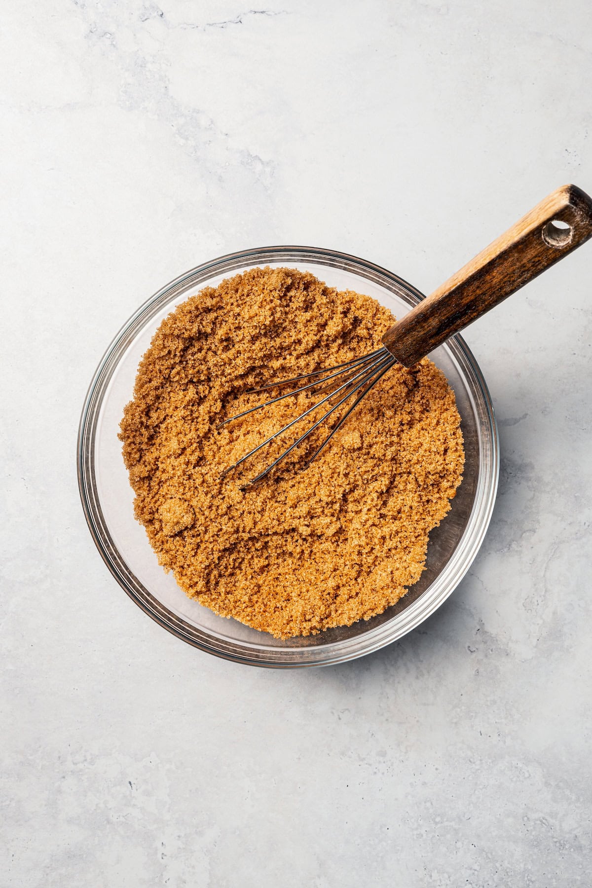 This cinnamon roll recipe makes big, bakery-style cinnamon buns filled with gooey cinnamon sugar and topped with sweet cream cheese frosting. Cinnamon sugar combined in a bowl with a whisk.