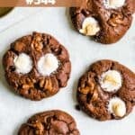 Four hot chocolate cookies topped with marshmallows.