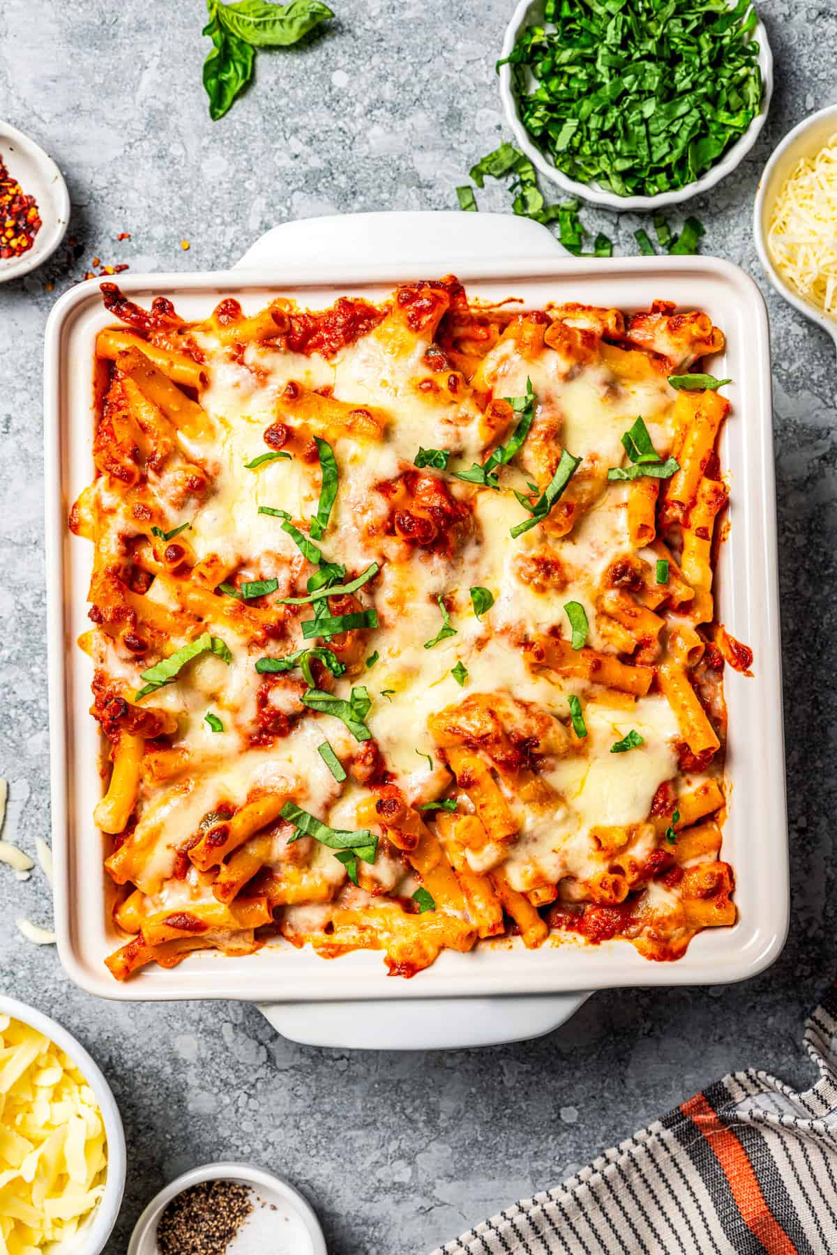 My easy baked ziti recipe is a weeknight-friendly pasta casserole with rich homemade meat sauce and three kinds of melty Italian cheese. Baked ziti in a baking dish.