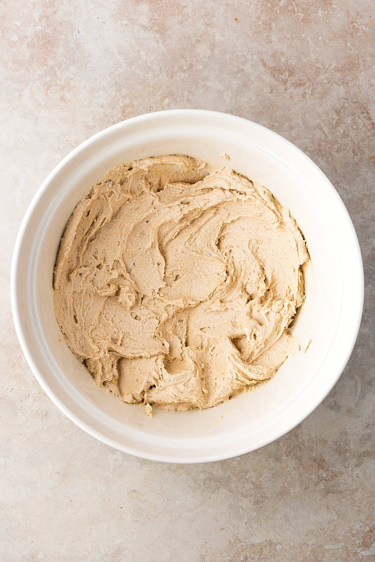 Thick, chewy, and soft gingerbread cookies flavored with warm spices and molasses. They're festive, cozy, and so easy to make for the holidays. A bowl of cookie dough.