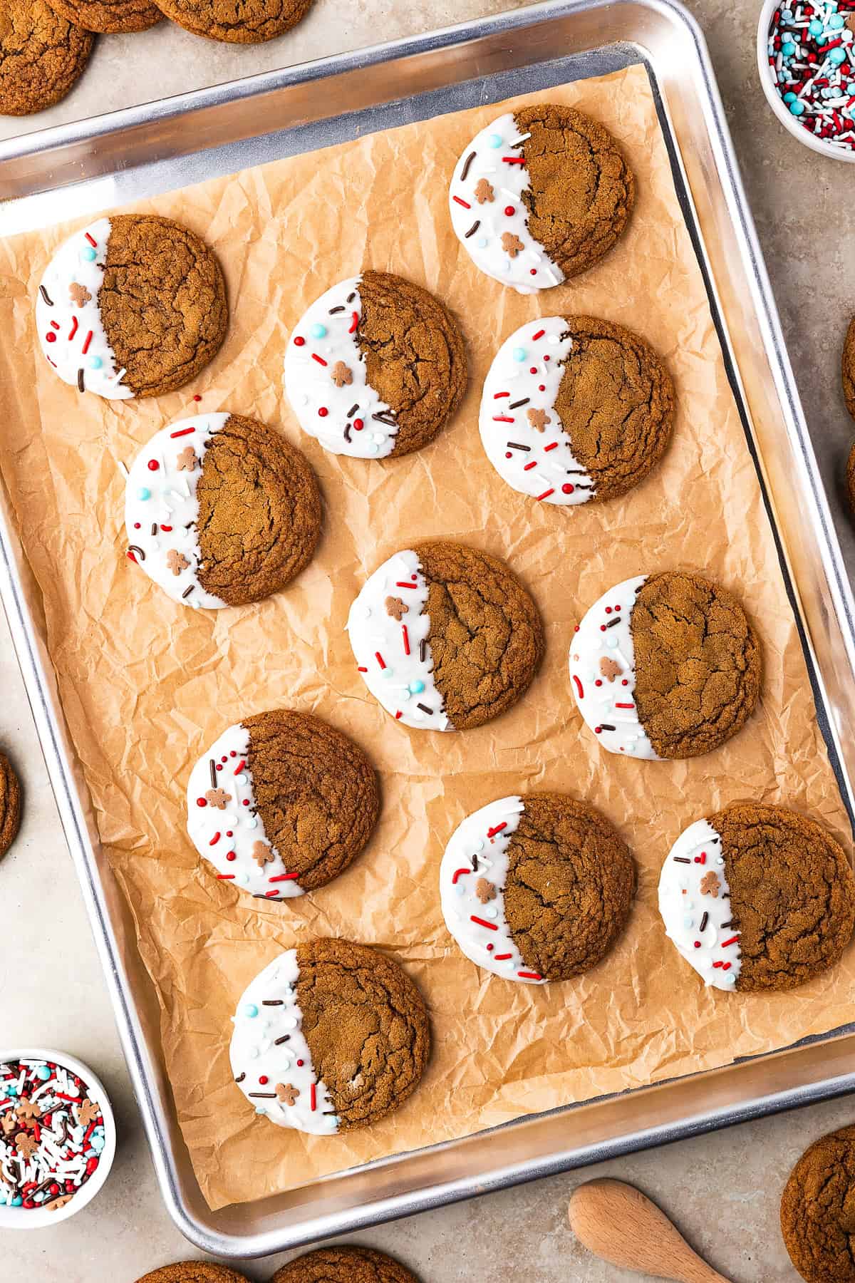 Thick, chewy, and soft gingerbread cookies flavored with warm spices and molasses. They're festive, cozy, and so easy to make for the holidays. Gingerbread cookies arranged on a baking sheet lined with parchment paper.