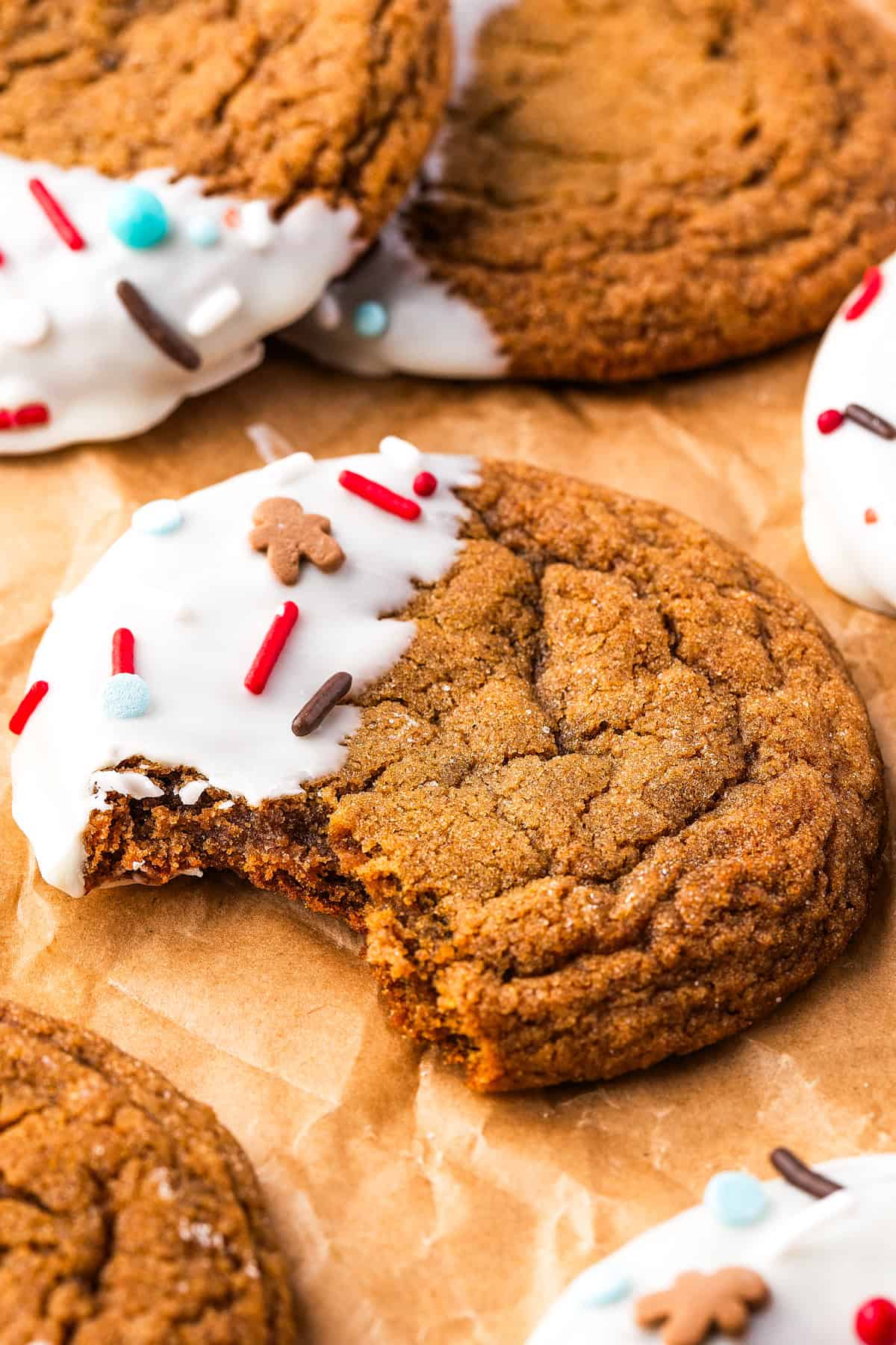 Thick, chewy, and soft gingerbread cookies flavored with warm spices and molasses. They're festive, cozy, and so easy to make for the holidays. Gingerbread cookie with a bite missing to expose the interior.