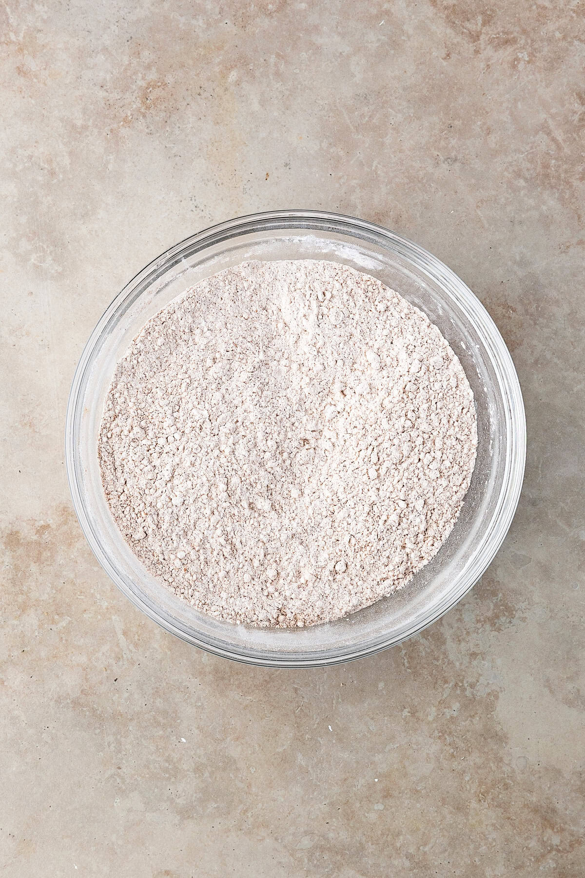 Thick, chewy, and soft gingerbread cookies flavored with warm spices and molasses. They're festive, cozy, and so easy to make for the holidays. A bowl of flour.