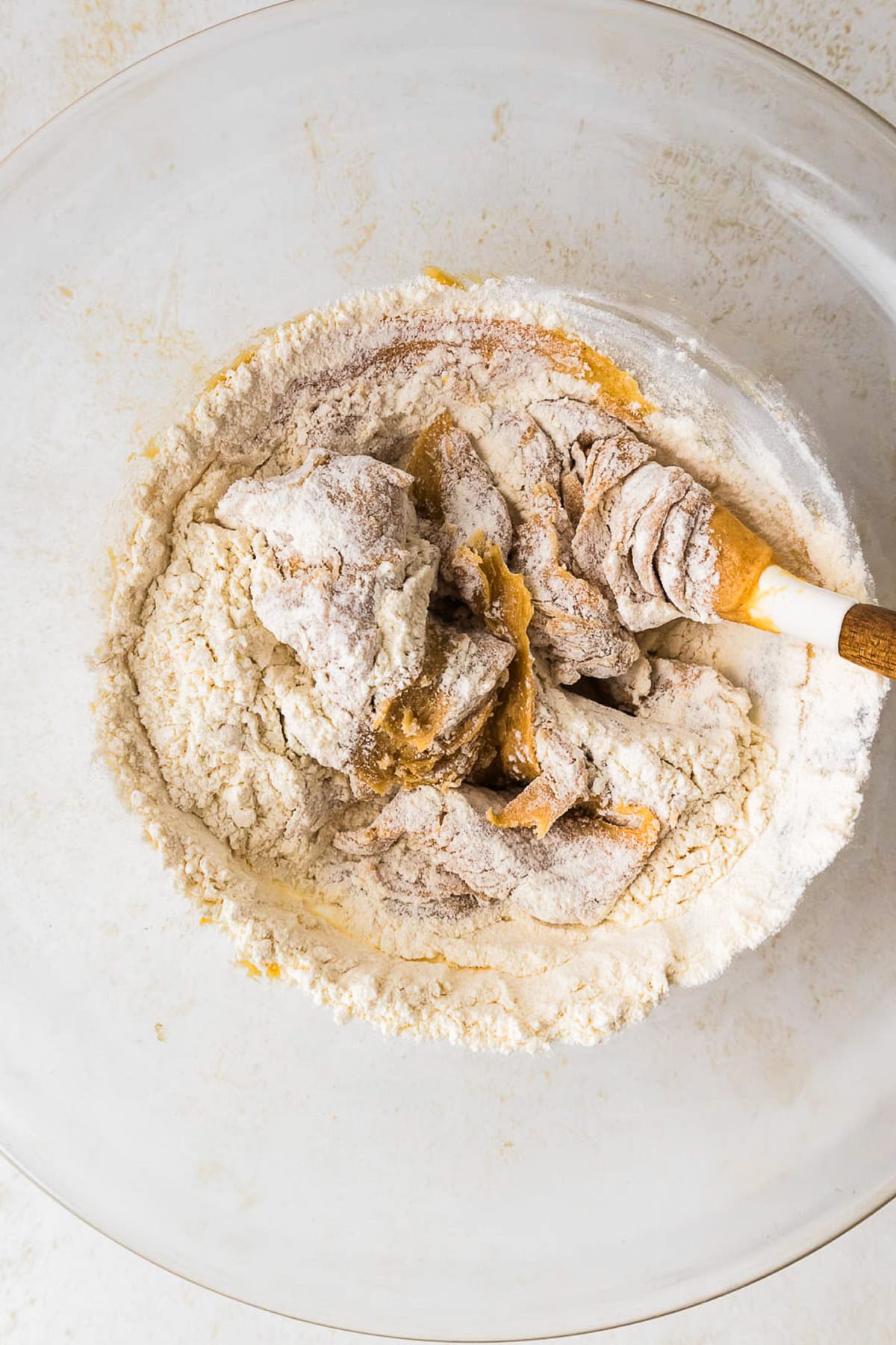 This peanut butter blossoms recipe makes soft, thick peanut butter cookies topped with a chocolate kiss. Easy to make and perfect for any occasion. Adding flour to a peanut butter cookie dough.
