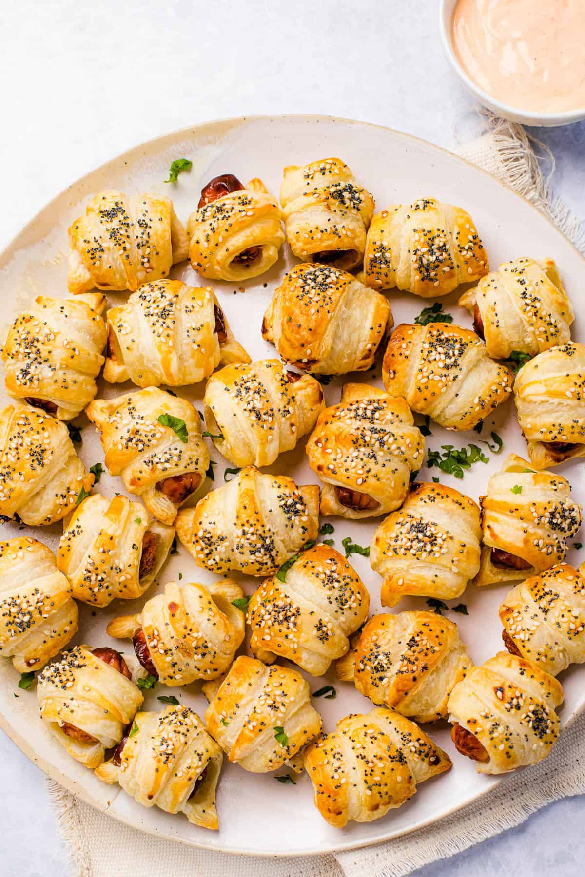 Pigs in a blanket snacks served on a big round platter.