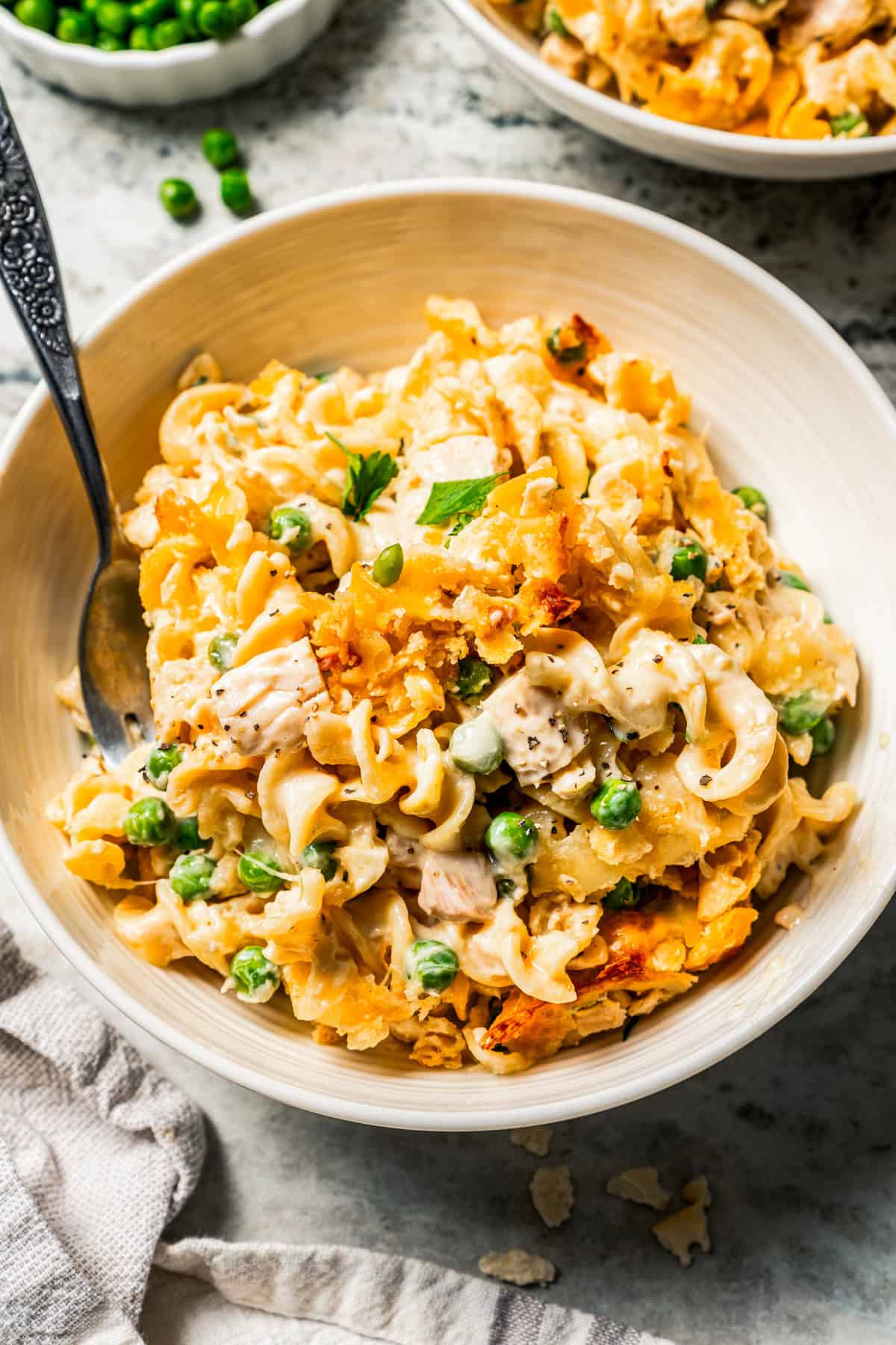 A serving of tuna casserole in a bowl with a fork.