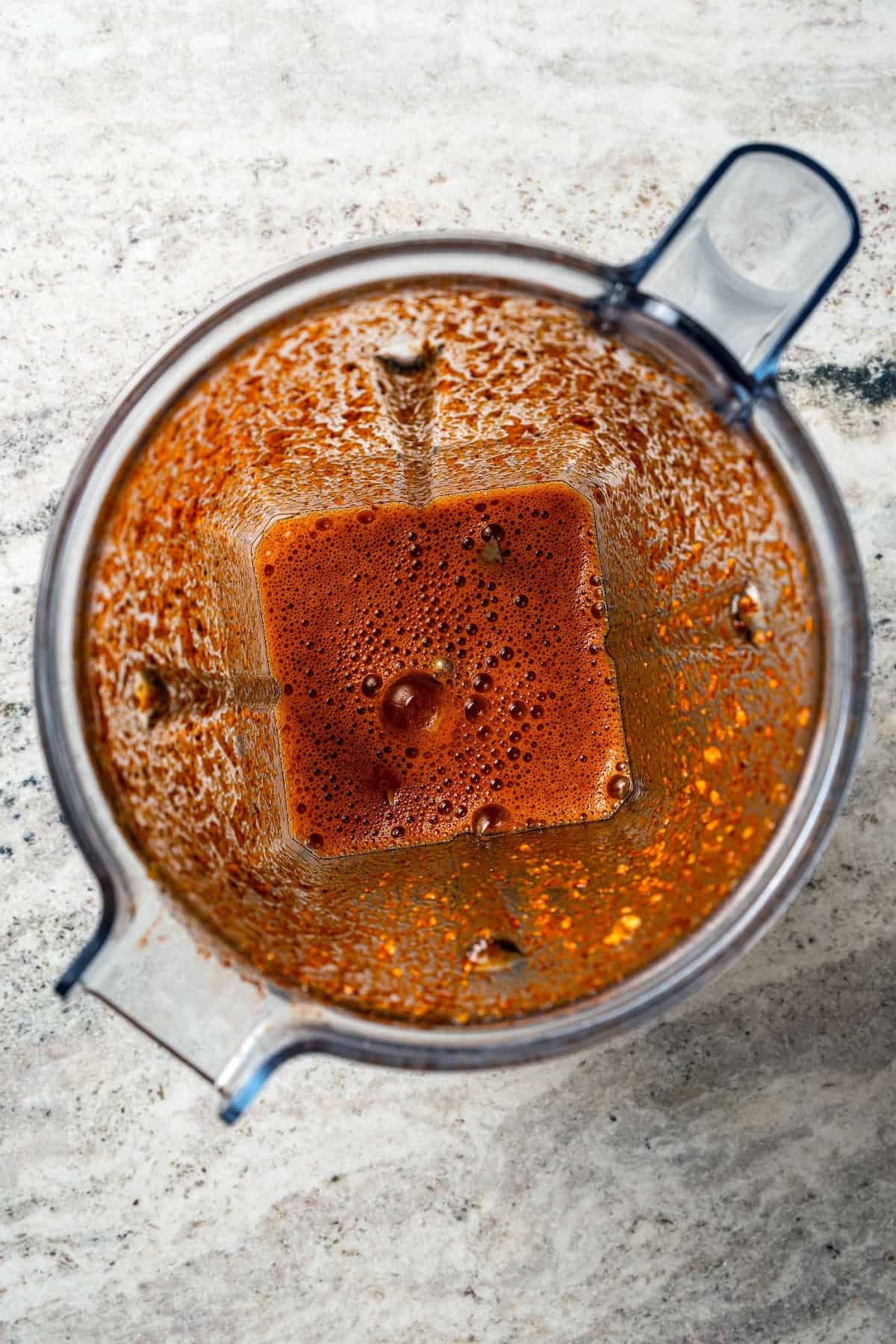 Crock pot carne asada has smoky spices and bright citrus, soaked into juicy shredded steak. Only 5 minutes to prep and perfect for tacos! Blended sauce inside the blender.