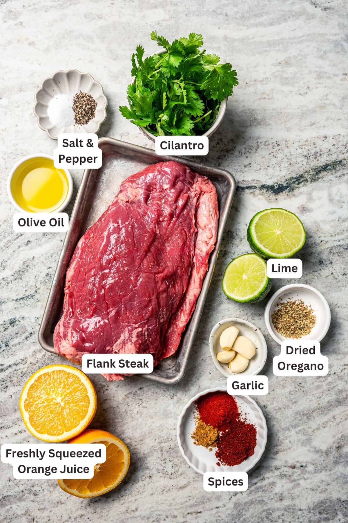 Crock pot carne asada has smoky spices and bright citrus, soaked into juicy shredded steak. Only 5 minutes to prep and perfect for tacos! Crock pot carne asada ingredients with text labels overlaying each ingredient.