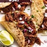 Beef machaca tacos on a plate.