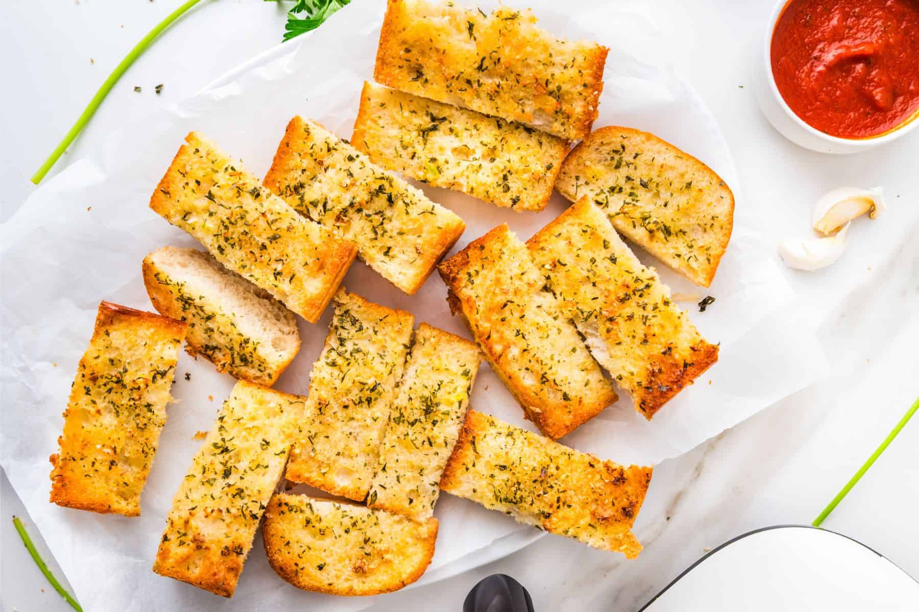 This tasty and easy air fryer garlic bread has crisp edges, a soft buttery center, and bold garlic flavor. A fast, oven-free side dish ready in 5 minutes. Air-fried garlic bread cut into several slices.