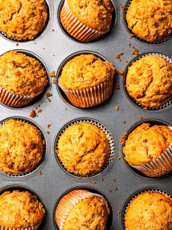Baked apple sauce muffins in a muffin tin.
