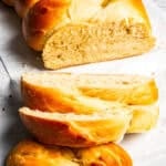 A loaf of challah with slices cut from the end.