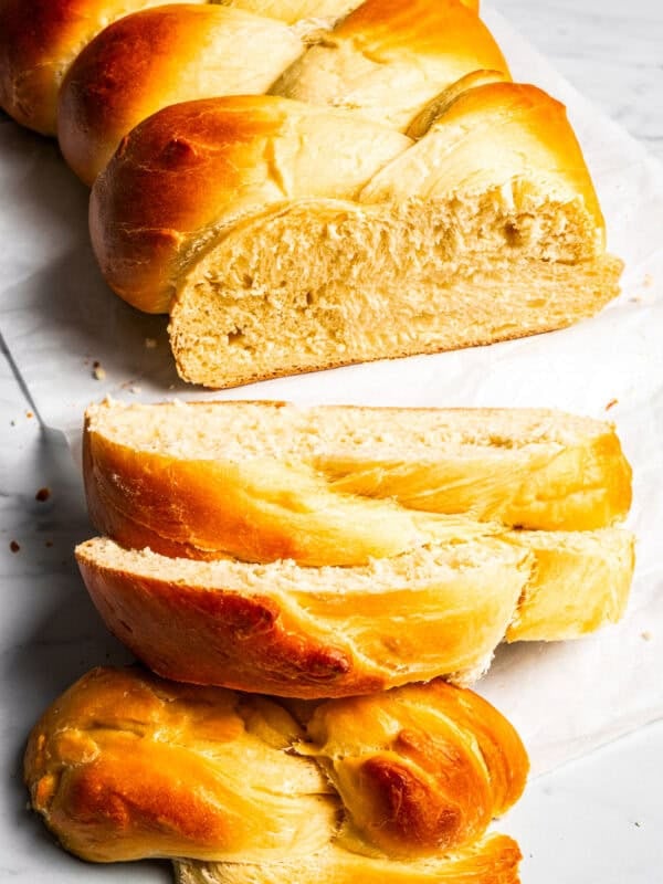 A loaf of challah with slices cut from the end.