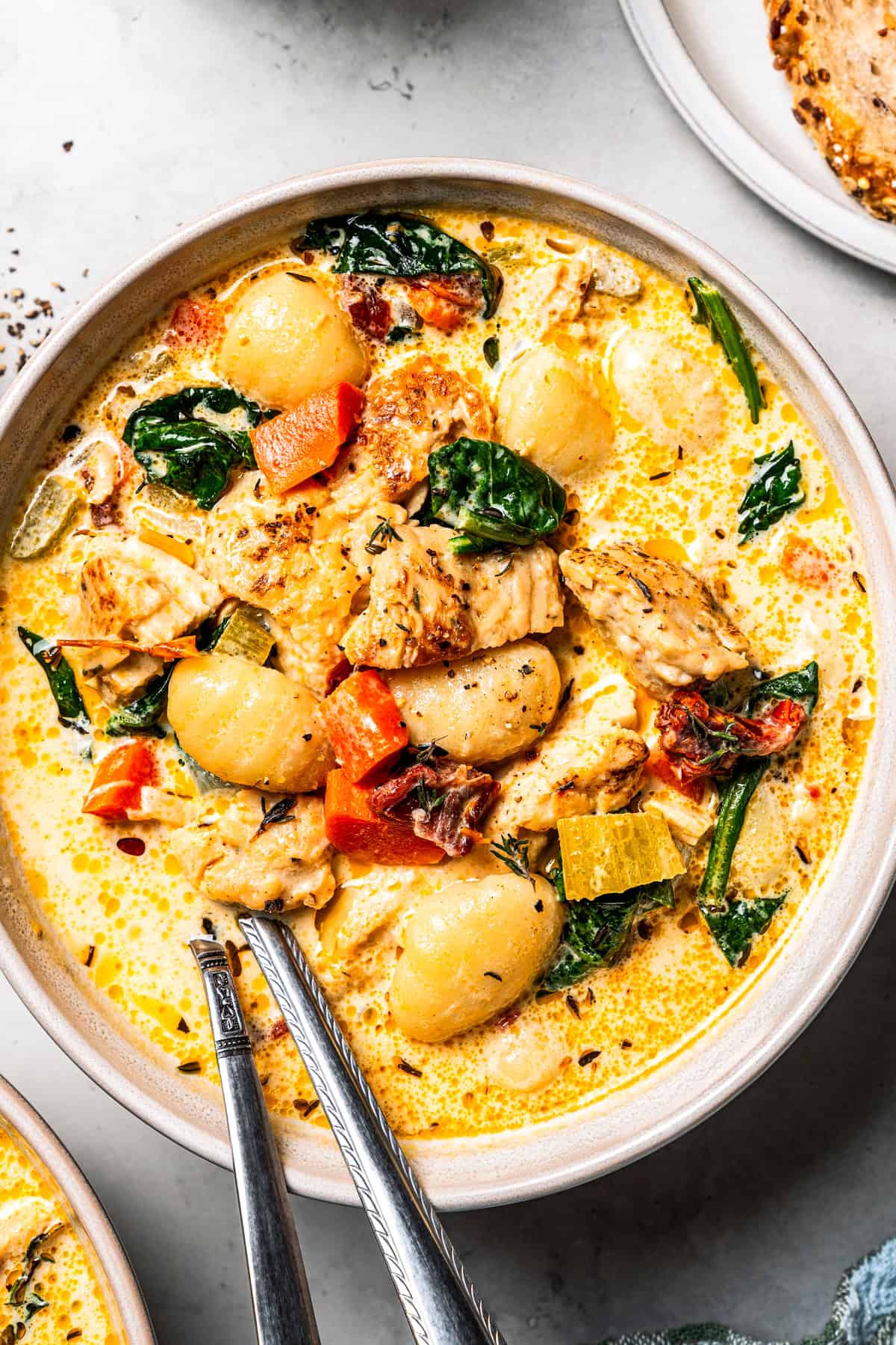 This chicken gnocchi soup is even better than the Olive Garden! It's ready in 20 minutes, extra creamy, and packed with flavorful ingredients. Close-up of chicken gnocchi soup served in a bowl.