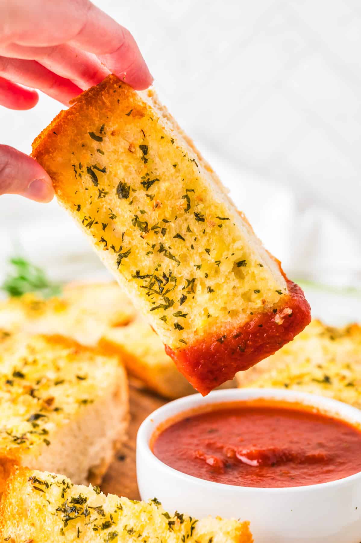 This tasty and easy air fryer garlic bread has crisp edges, a soft buttery center, and bold garlic flavor. A fast, oven-free side dish ready in 5 minutes. Dunking garlic bread in marinara sauce.