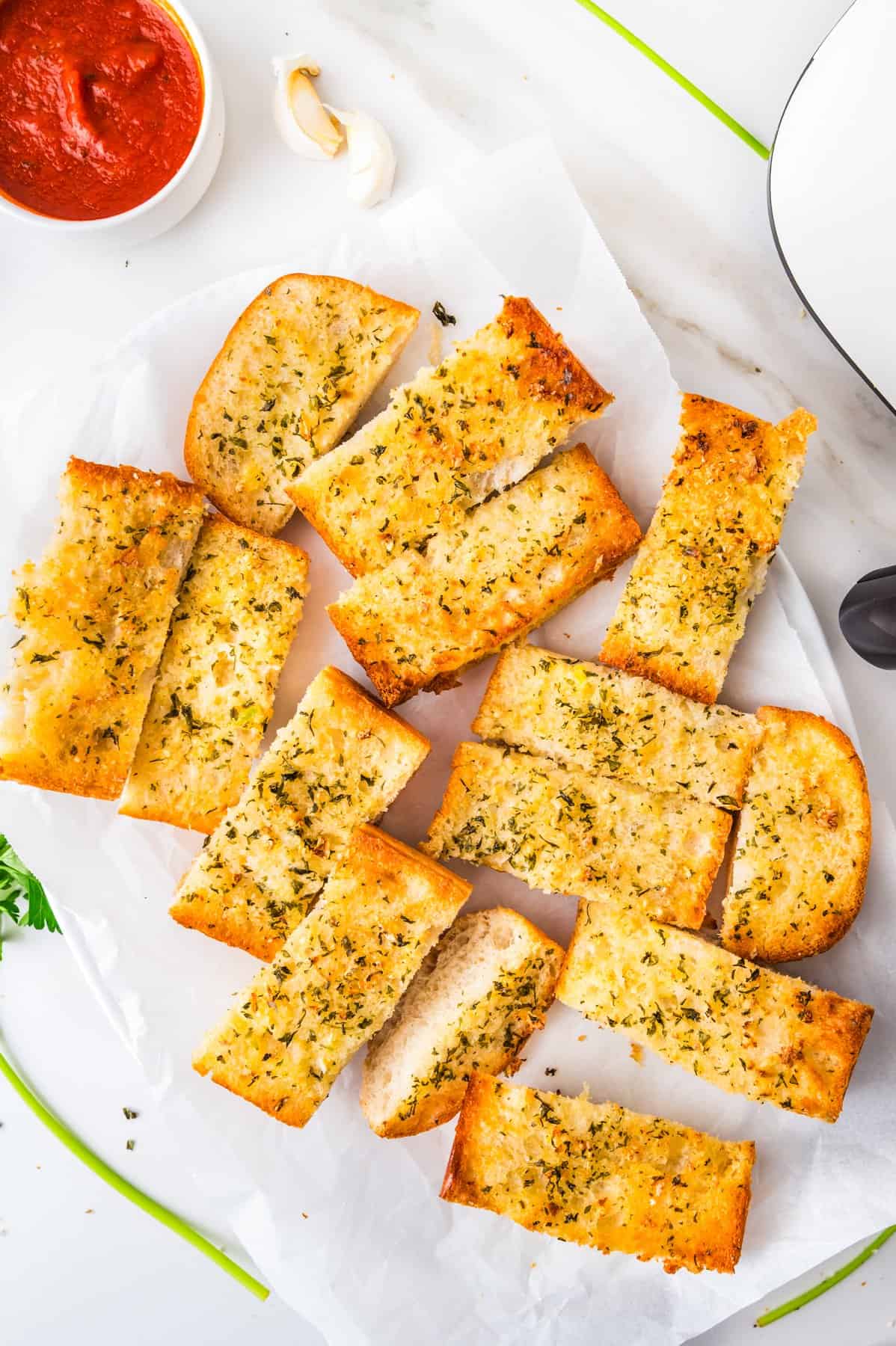This tasty and easy air fryer garlic bread has crisp edges, a soft buttery center, and bold garlic flavor. A fast, oven-free side dish ready in 5 minutes. Air-fried garlic bread cut into several slices.