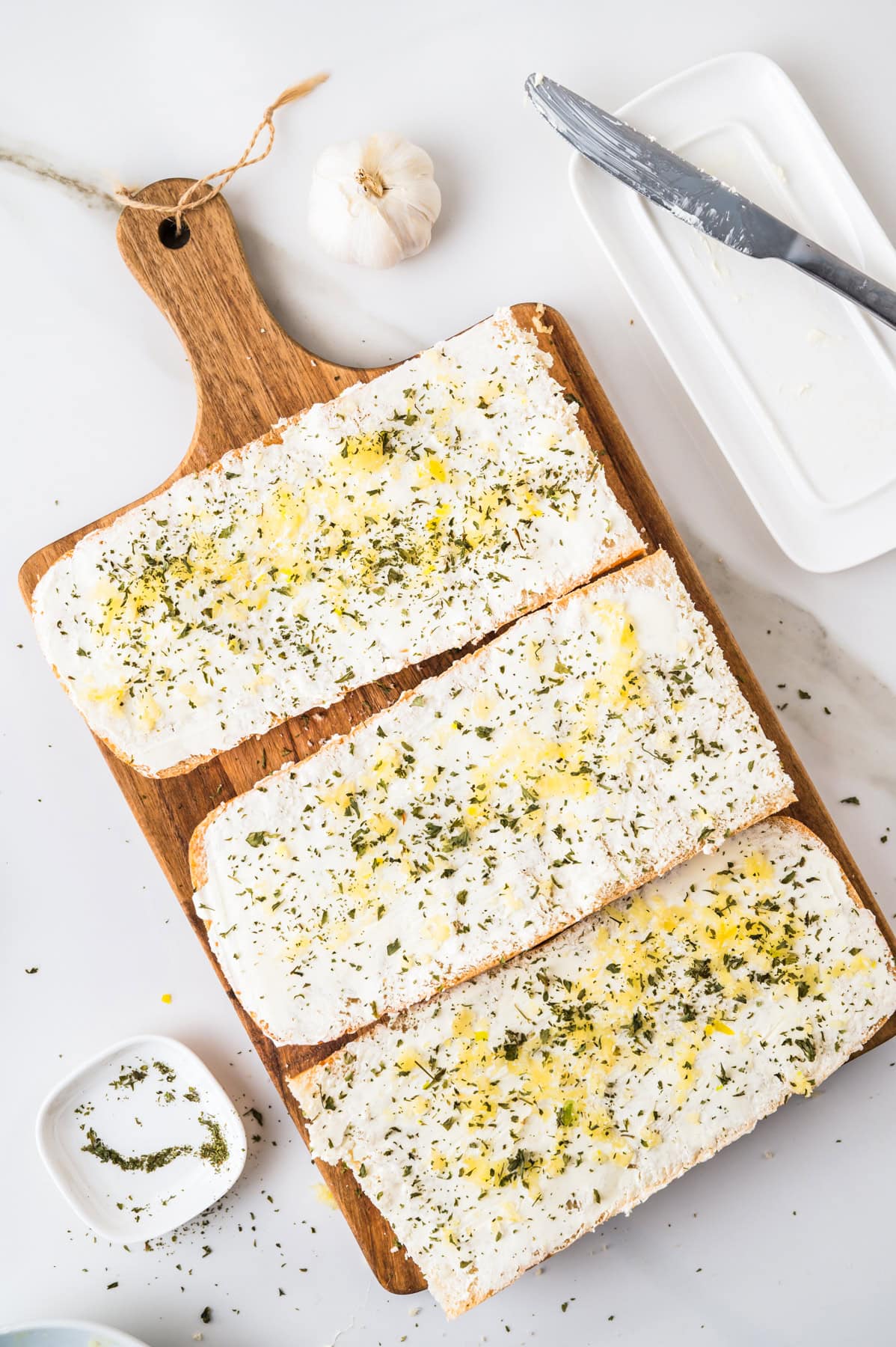 This tasty and easy air fryer garlic bread has crisp edges, a soft buttery center, and bold garlic flavor. A fast, oven-free side dish ready in 5 minutes. Bread halves topped with a spread of butter, minced garlic, and parsley.