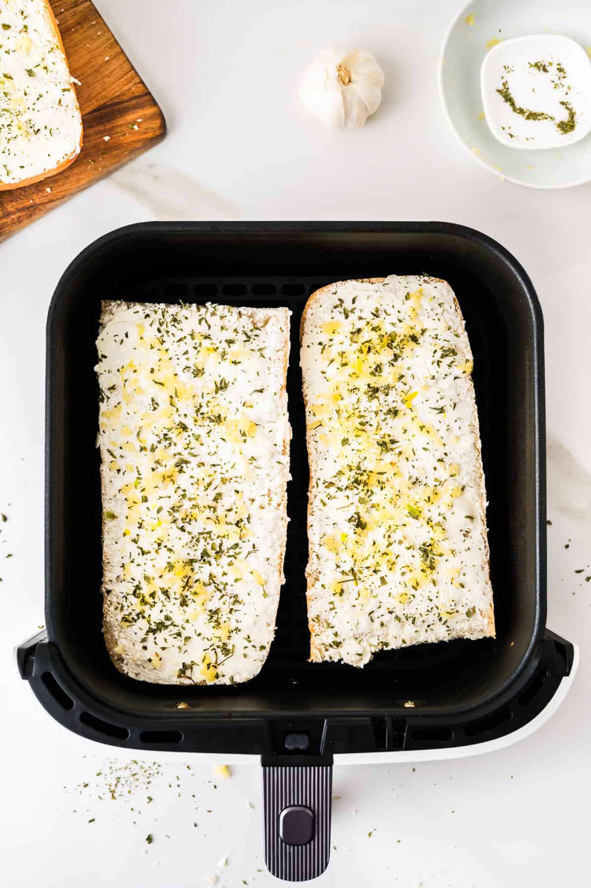 This tasty and easy air fryer garlic bread has crisp edges, a soft buttery center, and bold garlic flavor. A fast, oven-free side dish ready in 5 minutes. Two bread halves in an air fryer basket.