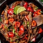 Overhead view of Beijing beef in a large skillet.