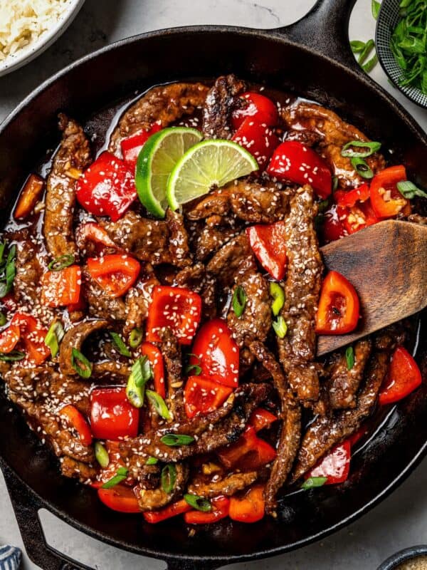 Overhead view of Beijing beef in a large skillet.