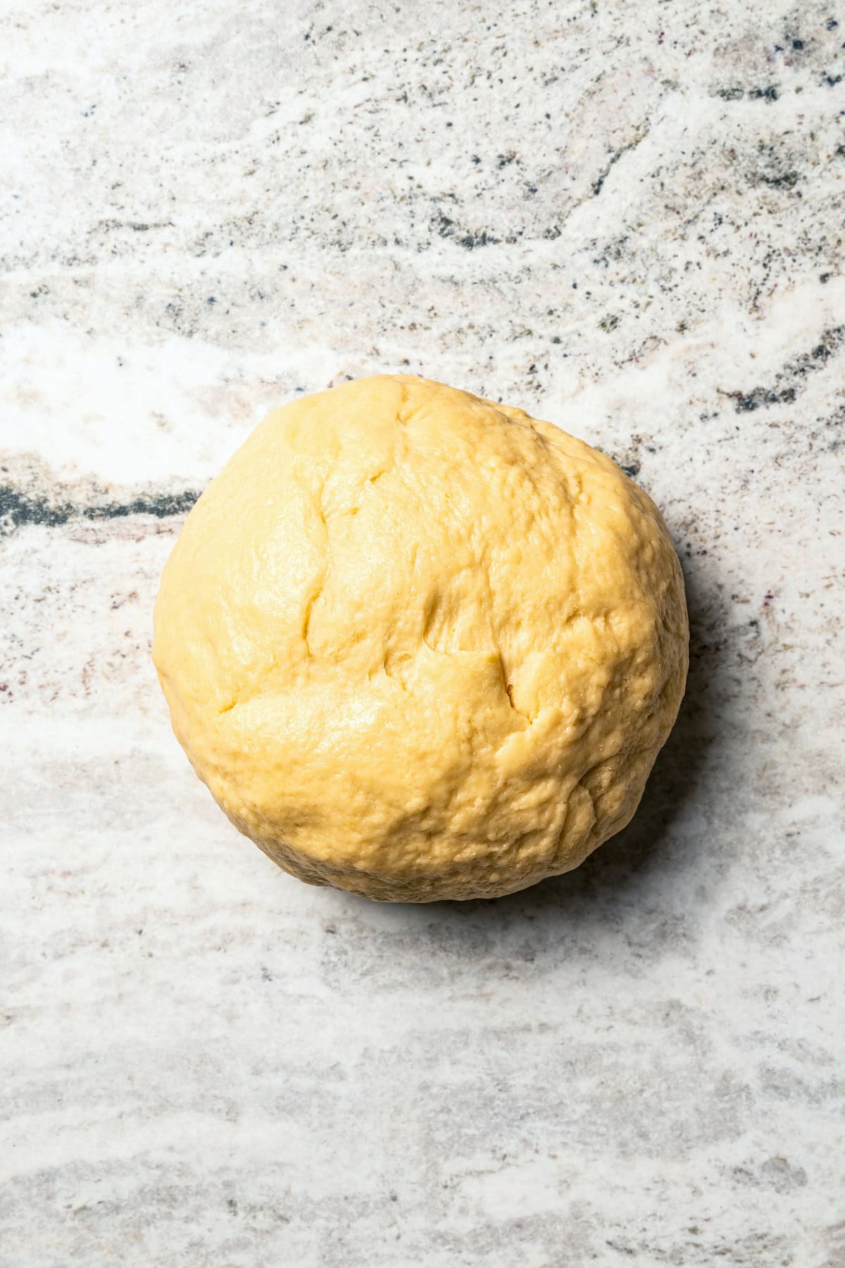 Hawaiian roll dough shaped into a ball.