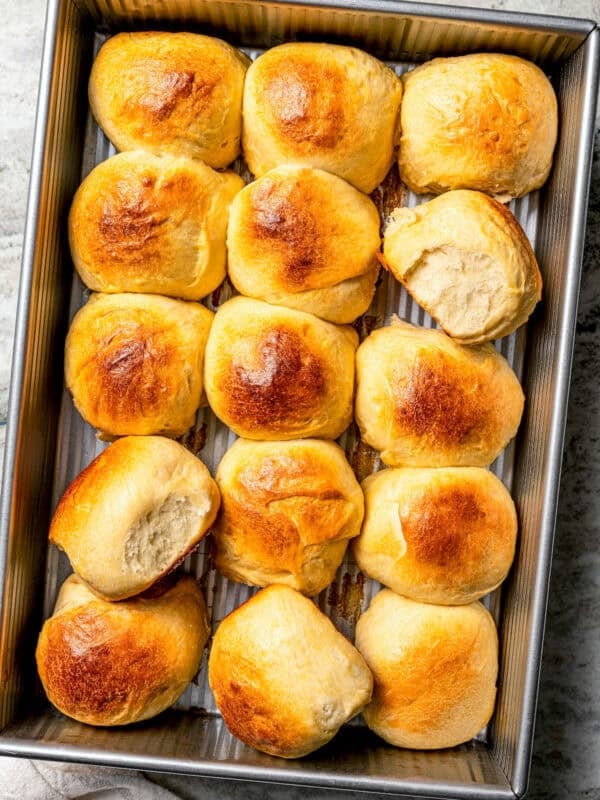 Baked Hawaiian rolls arranged in a baking tray.