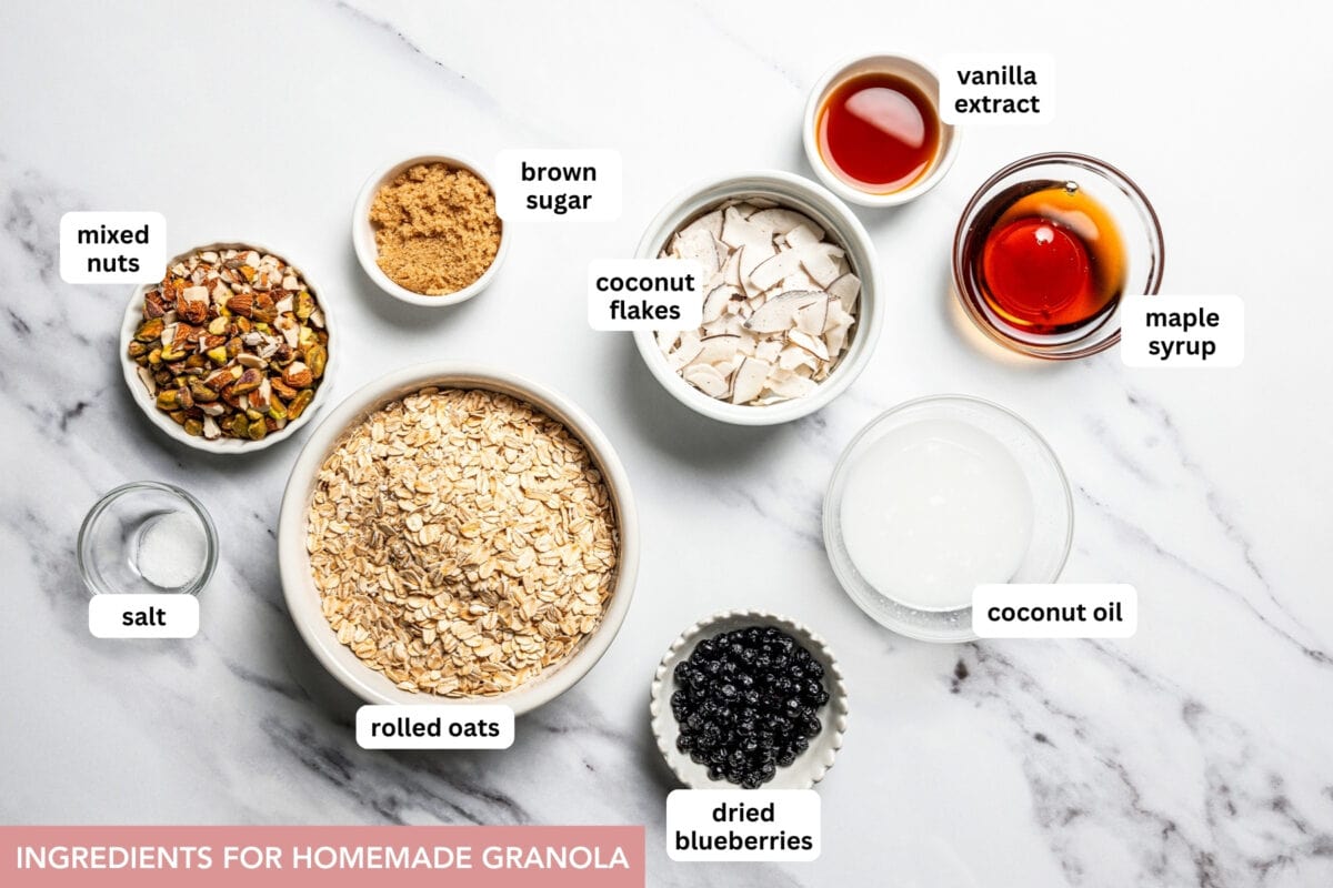 This homemade granola recipe with rolled oats, maple syrup, and brown sugar is sweet, crunchy, and you can make a big batch in the oven! Homemade granola ingredients with text labels overlaying each ingredient.