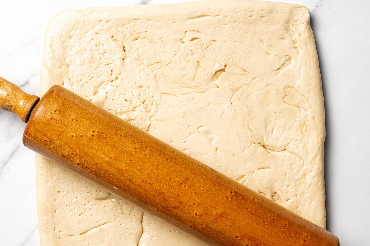 Rolled out dough with a rolling pin.