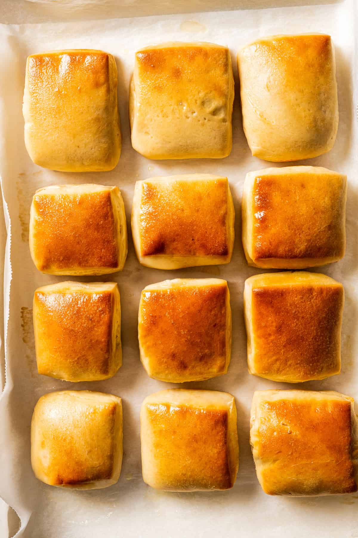 Baked Texas Roadhouse rolls on a baking sheet.