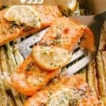 Baked salmon fillets in a baking dish with cooked asparagus.