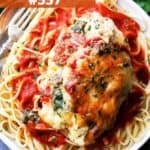 Cooked stuffed chicken breast served over fettuccine pasta with tomato sauce.
