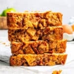 Slices of apple bread stacked on a countertop.