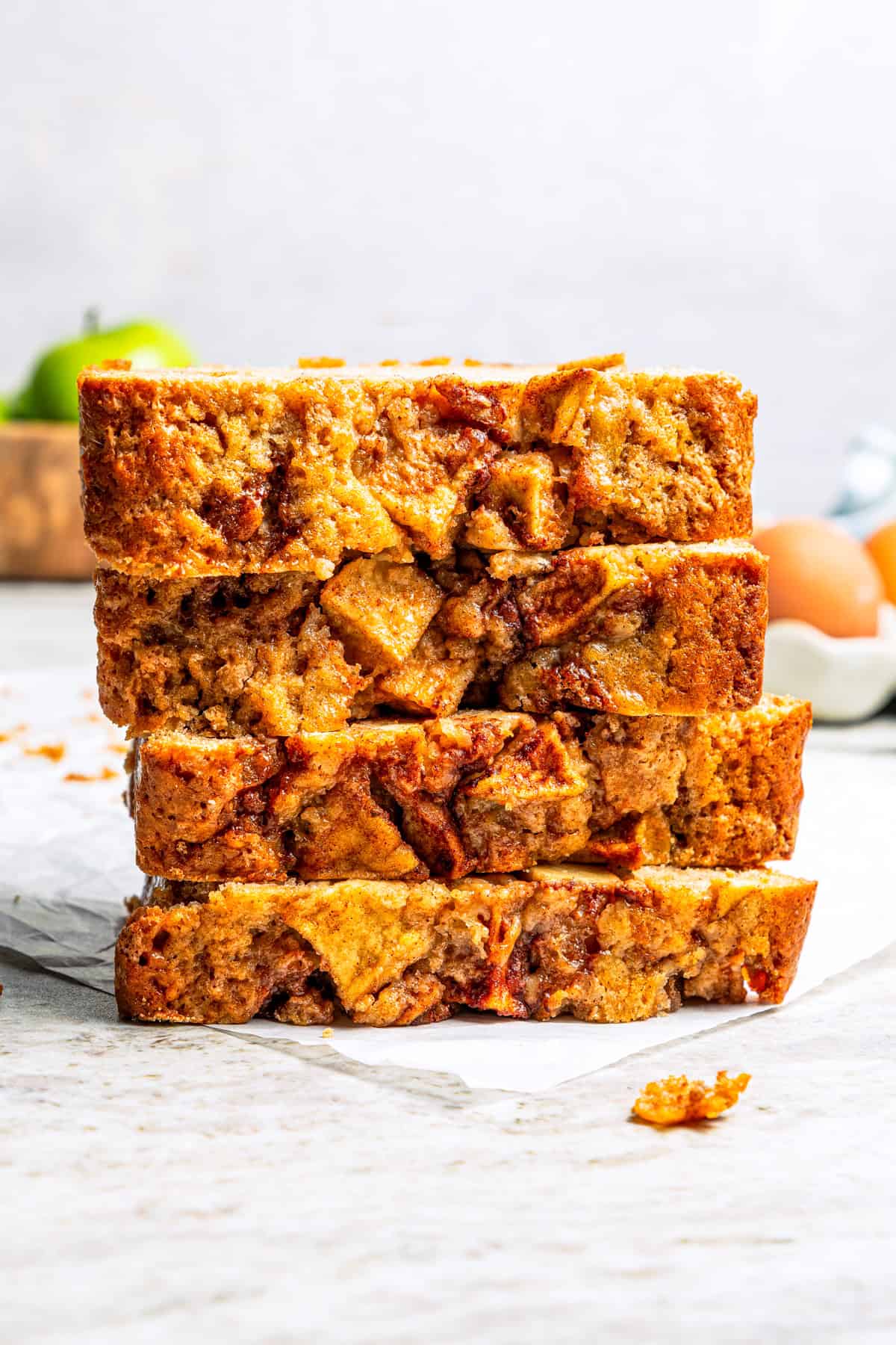 Slices of apple bread stacked on a countertop.