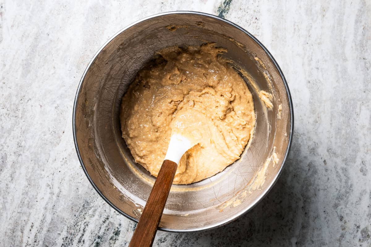 Apple bread batter in a bowl with a spatula.