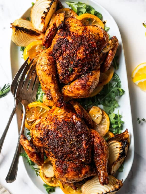 Two Cornish hens on a platter.