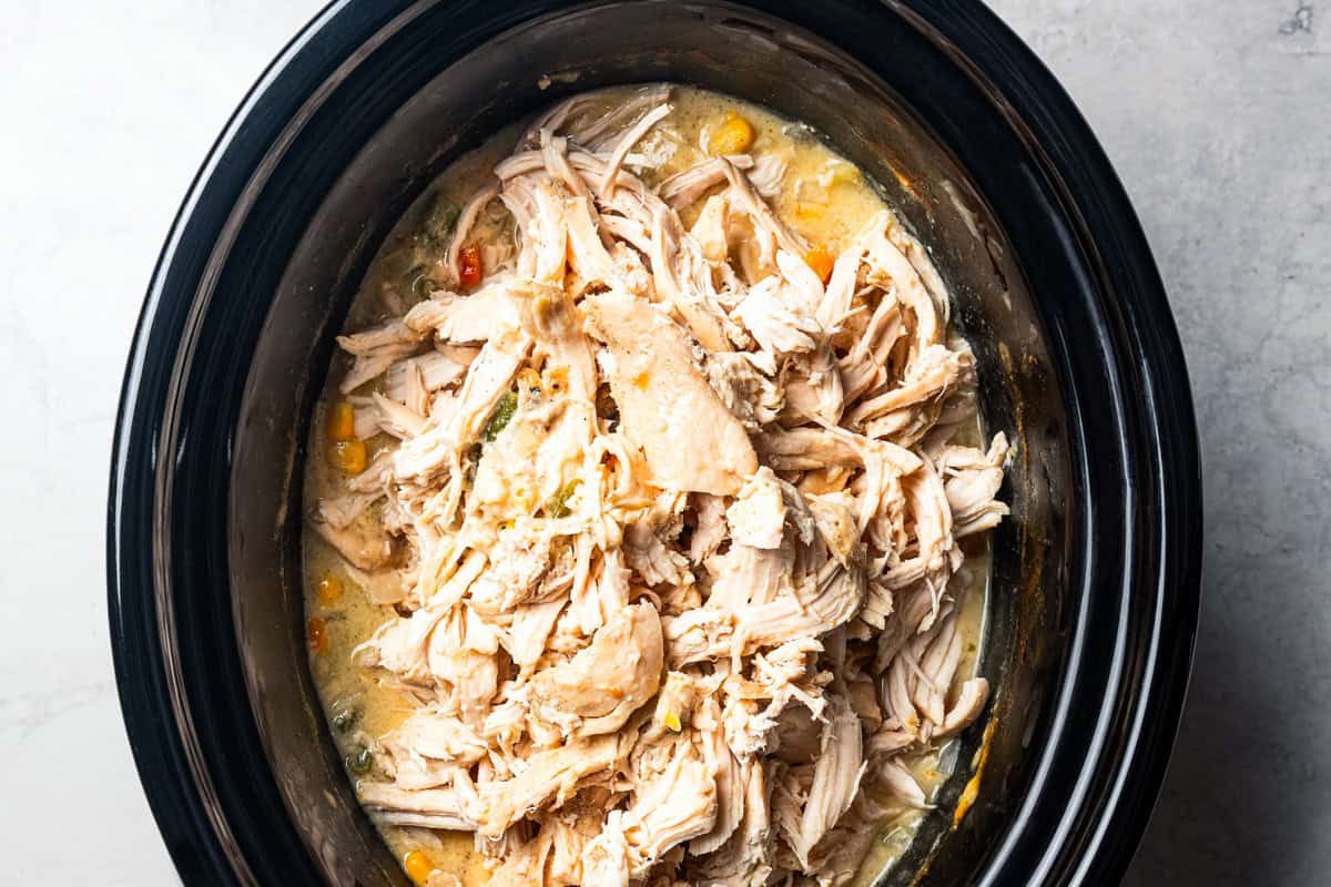 Shredded chicken added back into the slow cooker.