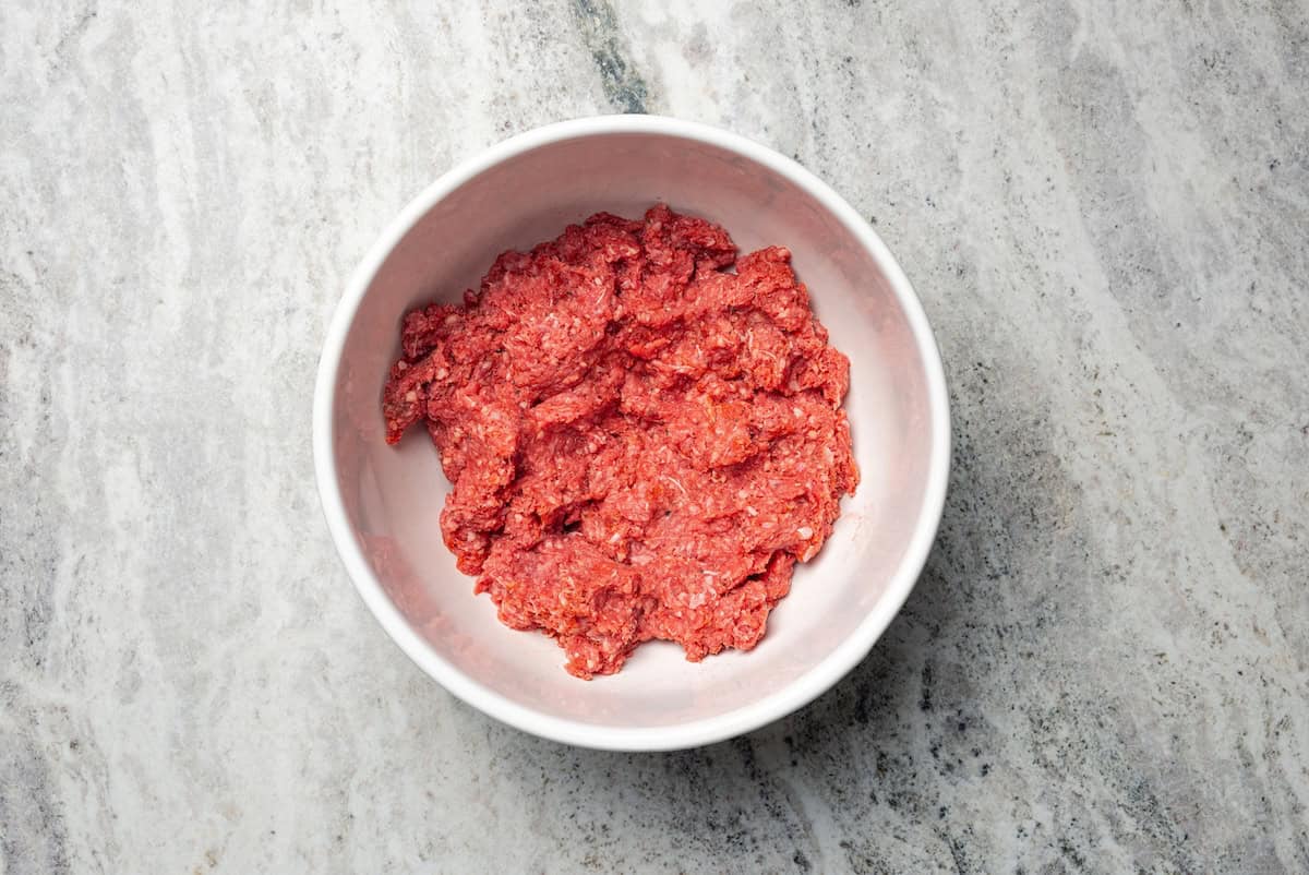 Seasoned hamburger meat in a bowl.