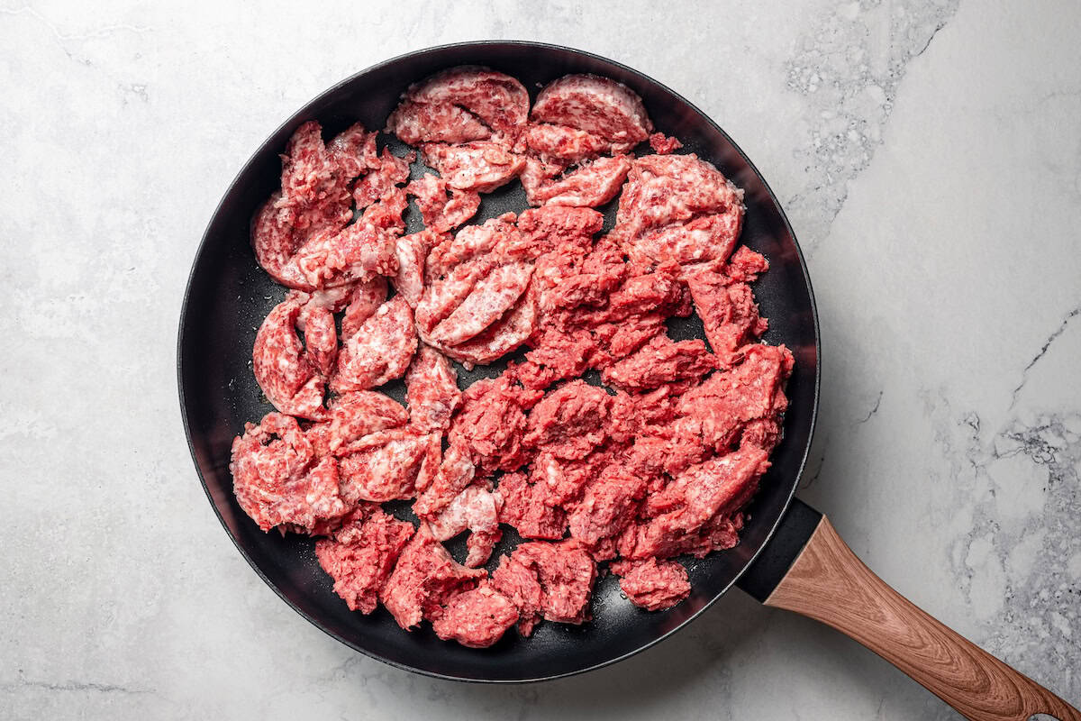 Broken-up ground meat in a skillet.