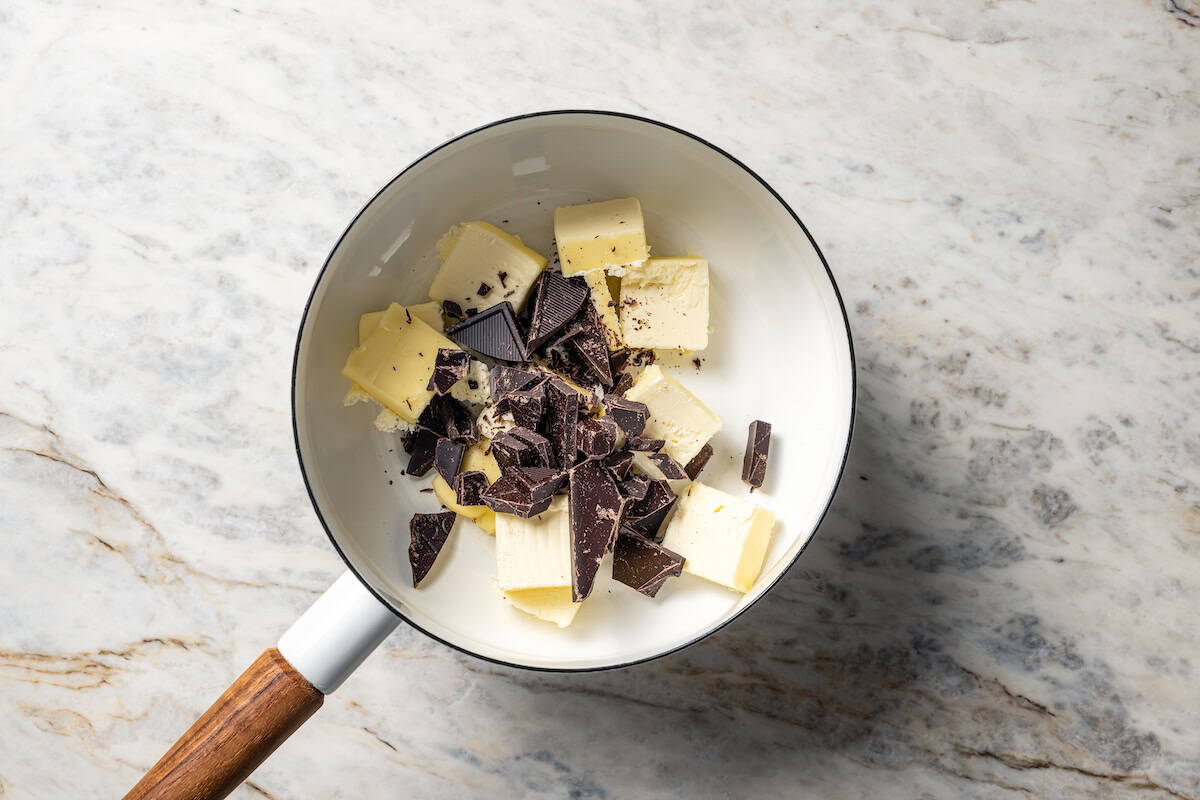Chocolate and butter combined in a saucepan.