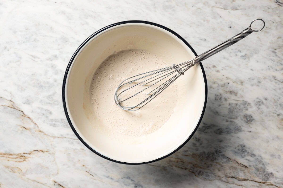 Heavy cream and vanilla whisked together in a bowl.