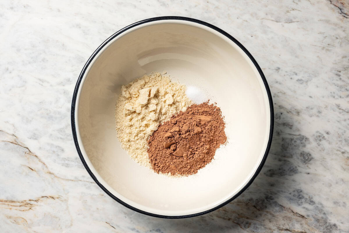 Almond flour, cocoa powder, and salt combined in a bowl.