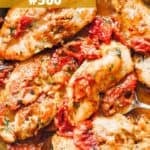 A skillet with pan seared chicken breasts tossed with sundried tomatoes and a creamy sauce.