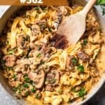 Cooked noodles and beef in a skillet to make beef stroganoff.