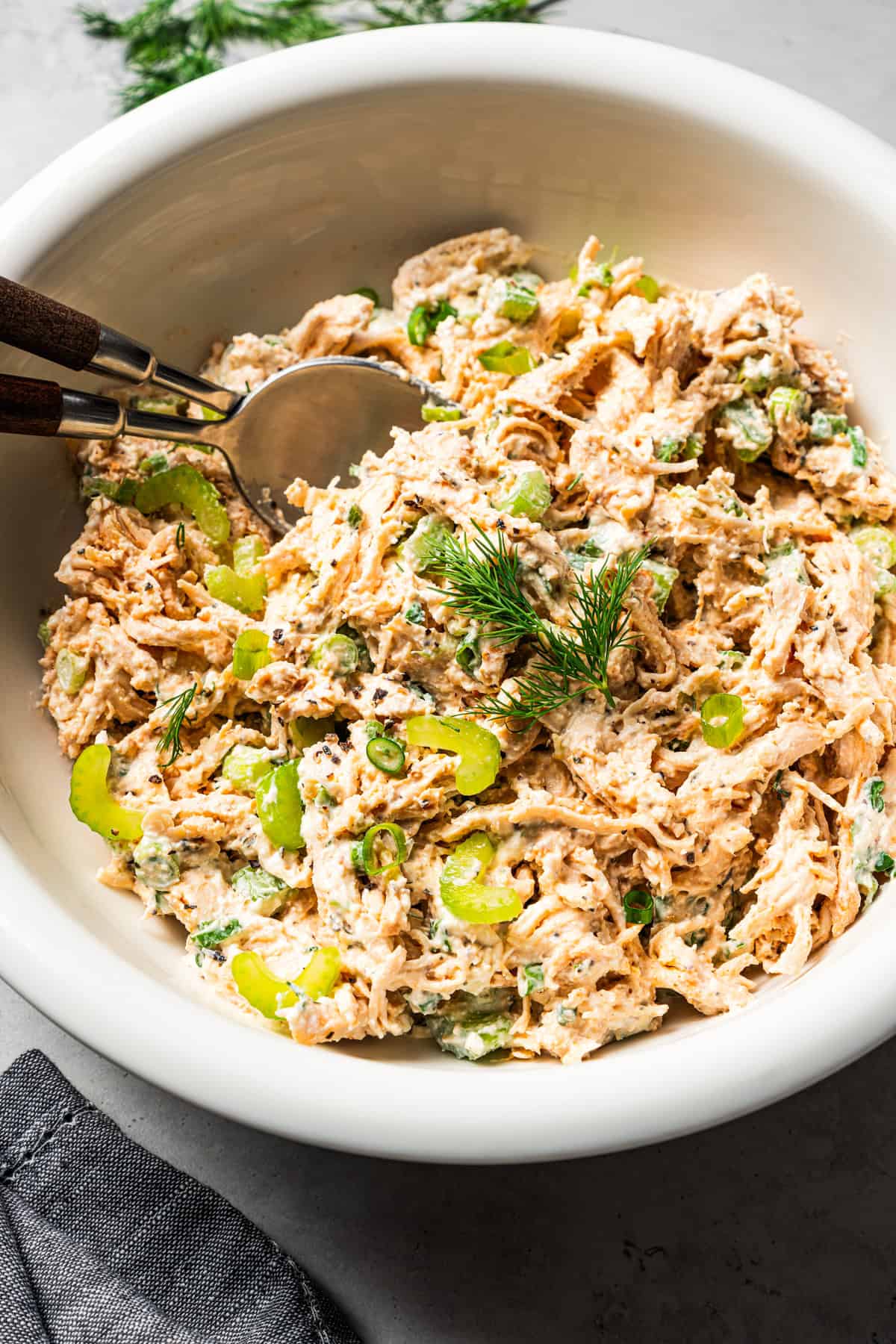 Creamy chicken salad in a bowl with two spoons.